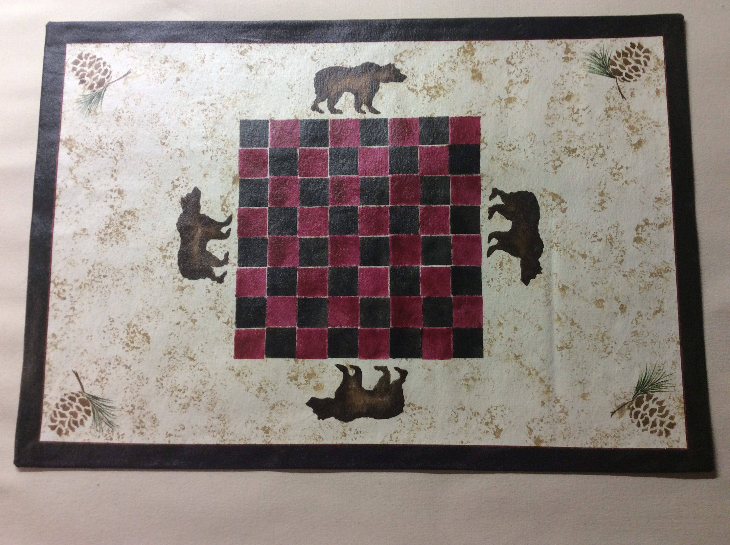 A canvas floorcloth with a checkerboard design on a white background on it.