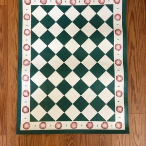 A green and white checkered floorcloth with red spots around the edge.